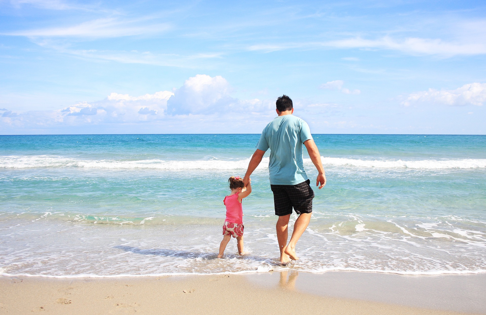 man and girl on beach