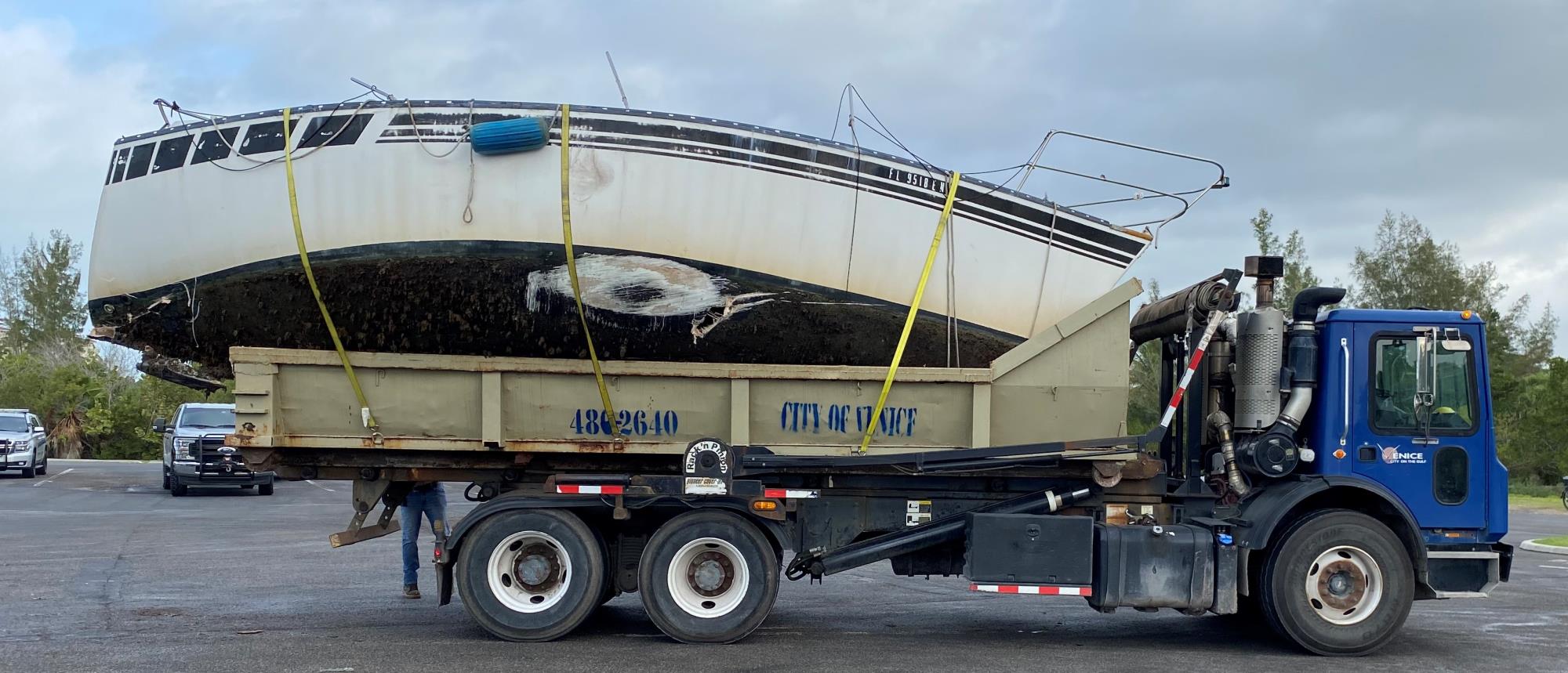 boat loaded on truck for disposal